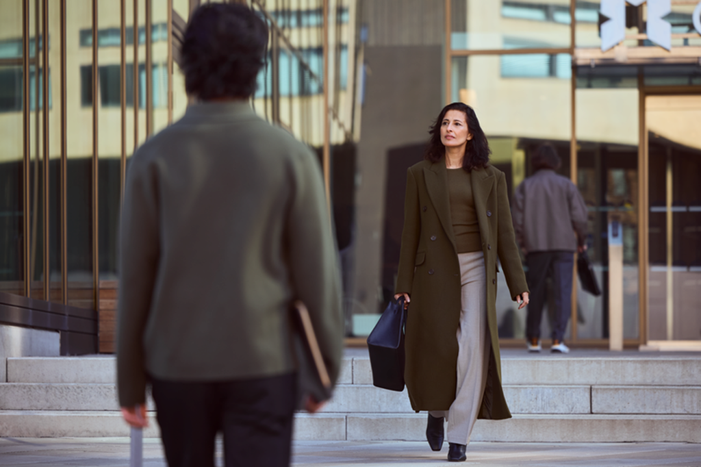Business woman and man walking in the street.